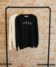 Tired Sweatshirt black fleece pullover on a rack showing the fit for casual layering and cosy home wear.