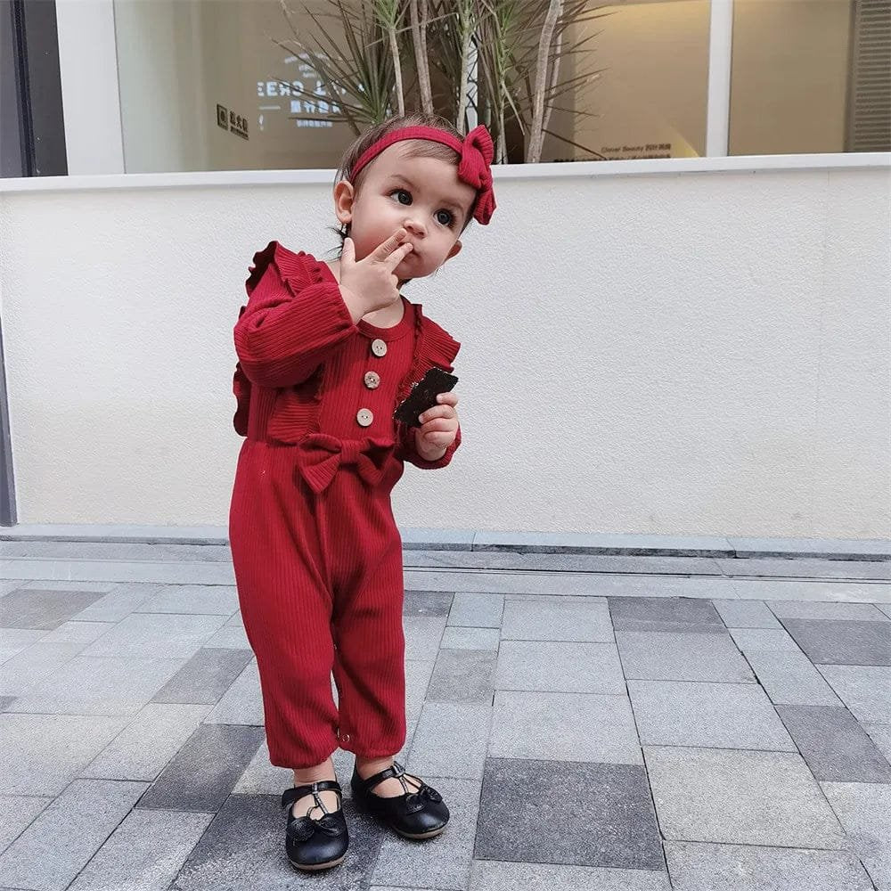 Red baby girl romper worn for everyday play, first steps and casual family outings.