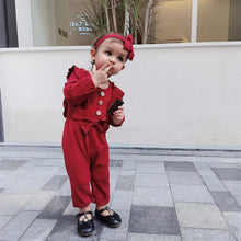 Red baby girl romper worn for everyday play, first steps and casual family outings.