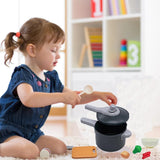 Child playing with toy kitchen set