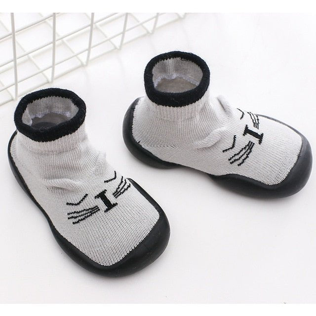 Pair of white pet socks with black accents