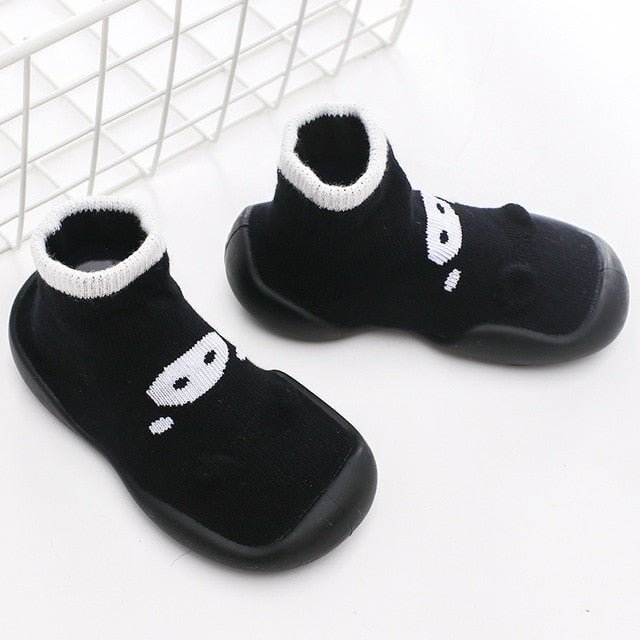 Black socks with white paw prints on a white background