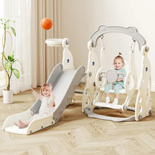 Toddler slide and swing play structure arranged in a home playroom for climbing, sliding, and swinging play.