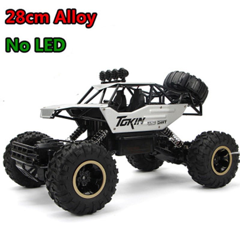 Tokin RC truck with oversized wheels close-up highlighting brand and build quality.