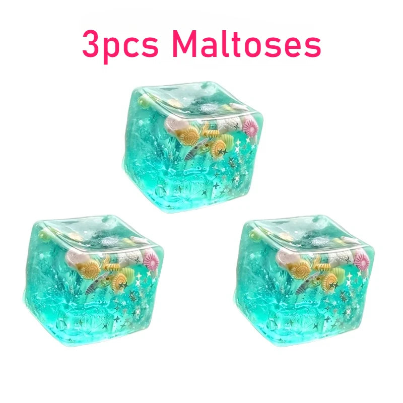 Three turquoise crystal-like cubes with decorative elements on a white background, labeled '3pcs Maltoses'.