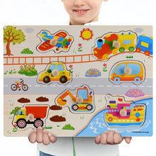 Child holding a Montessori wooden transportation puzzle from an interactive learning set for vehicle-themed play.