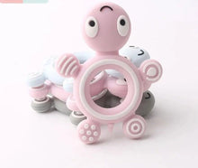 Turtle Silicone Teether in candy pink and white pastel design for baby-safe gum soothing.