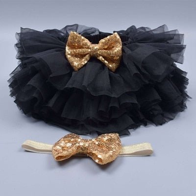 Flat lay of the black tulle tutu bloomers diaper cover and headband set for newborn gifting and outfit planning.