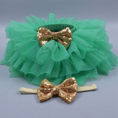 Ruffled green tulle newborn girl two-piece bloomers set for gifting, christmas mornings, and milestone pictures.