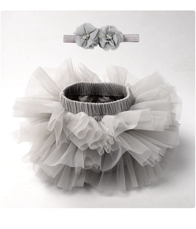 Front view of the grey tulle tutu bloomers diaper cover with headband for relaxed newborn dressing and photos.