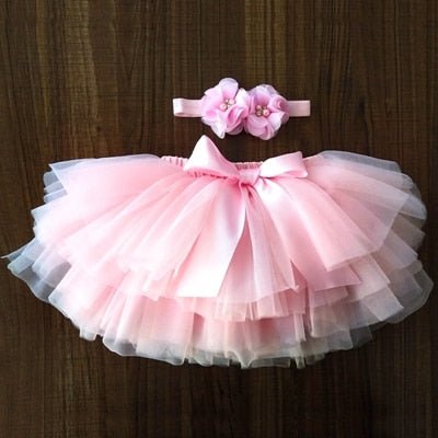Elegant pink tulle tutu bloomers and headband set for baby girl birthday celebrations and family gatherings.