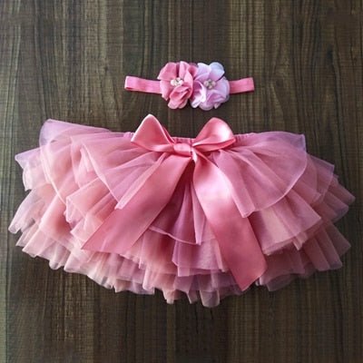 Soft ruffled pink tulle infant girl bloomers outfit with headband for stroller walks and warm-weather outings.