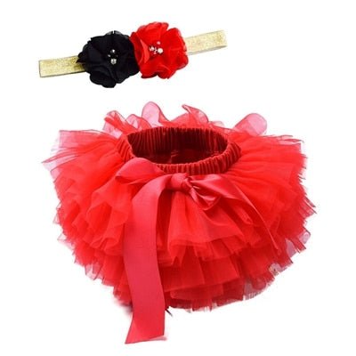 Soft layered red tulle on the tutu bloomers diaper cover for comfortable newborn wear during holiday gatherings.