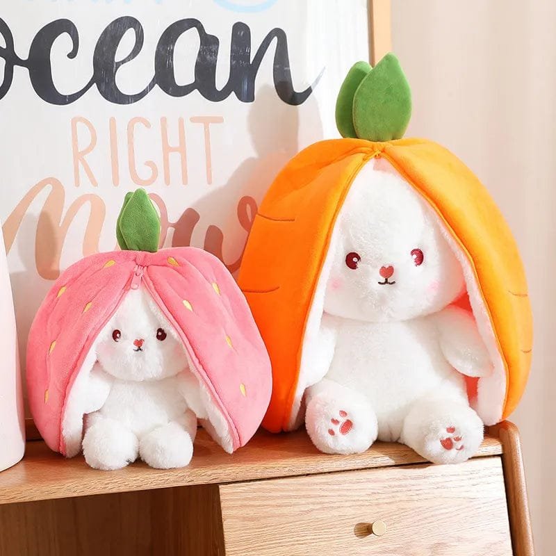 Two carrot rabbit soft toys tucked inside fruit-shaped plush bags for peekaboo play and toddler entertainment.