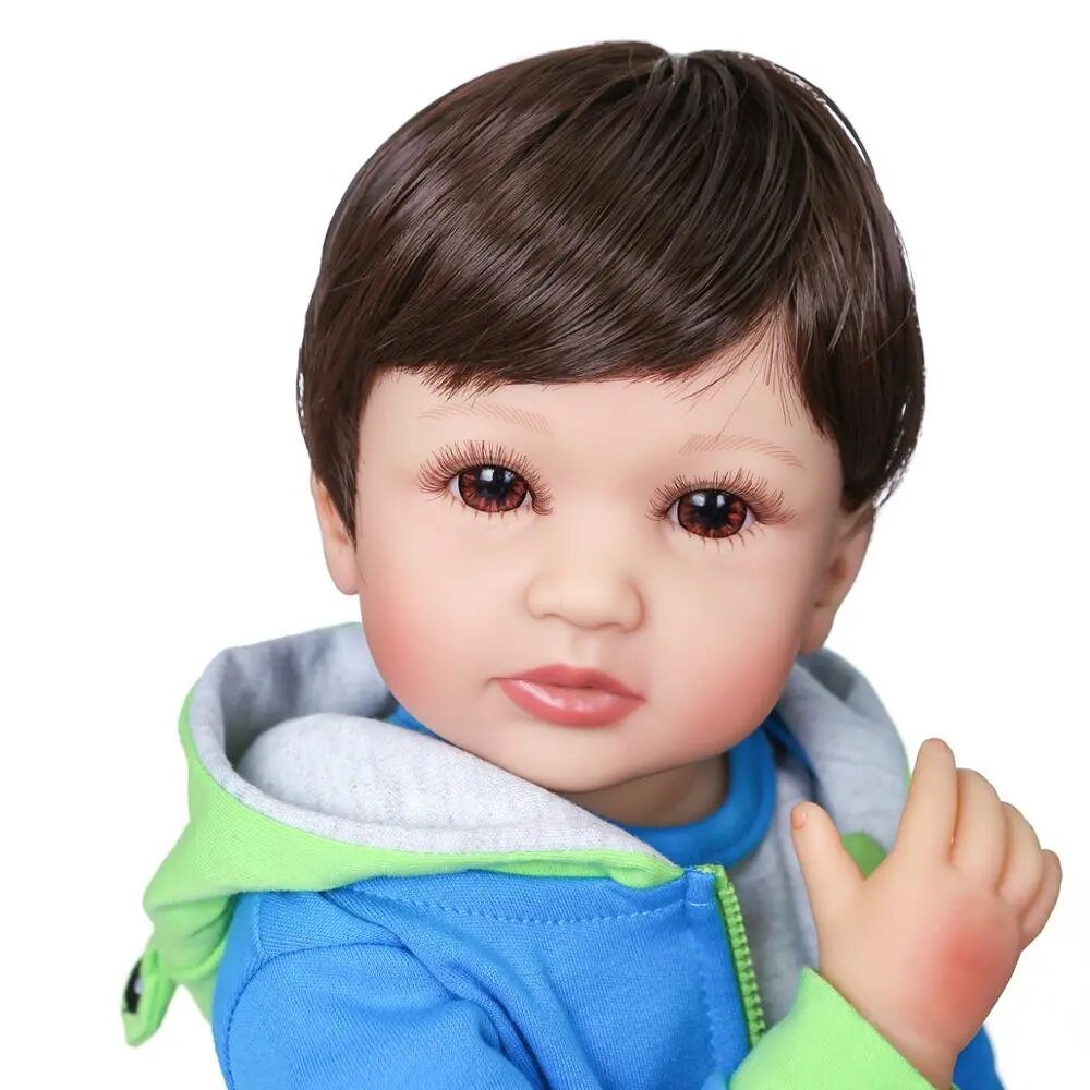 Two colour hair Reborn Baby Boy doll close-up in a blue and green jacket showing hand-rooted hair detail for collectors.