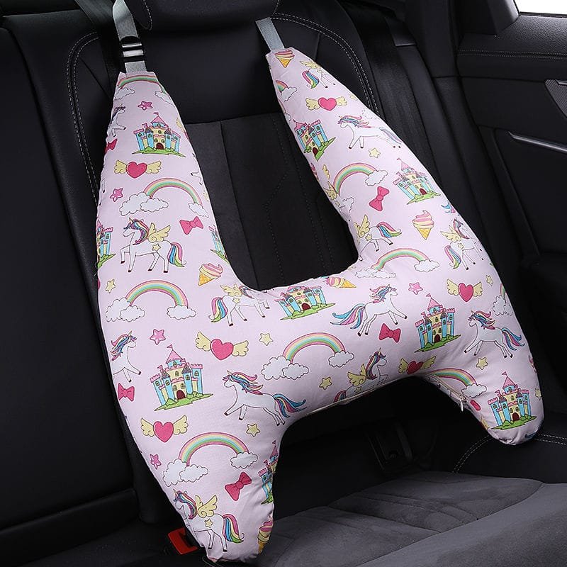 U-Shape Kids Travel Pillow in unicorn rainbow design fitted to a car headrest for restful naps on longer journeys.