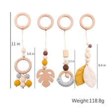 Baby teething toy with wooden rings and colorful beads, shown with measurements and weight.