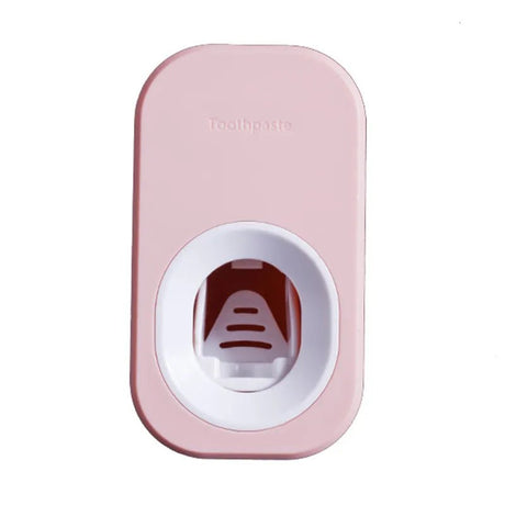 Pink and white toothpaste dispenser with 'Toothmatic' branding on a white background