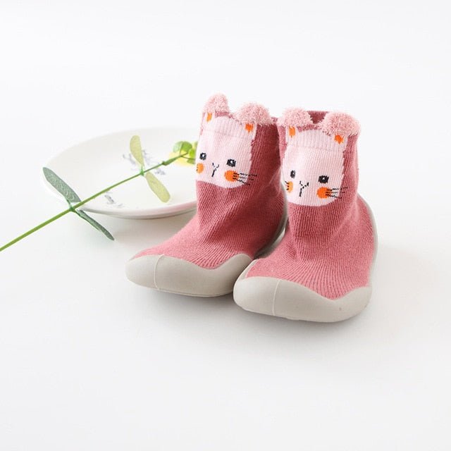 Pink baby socks with a cat face design