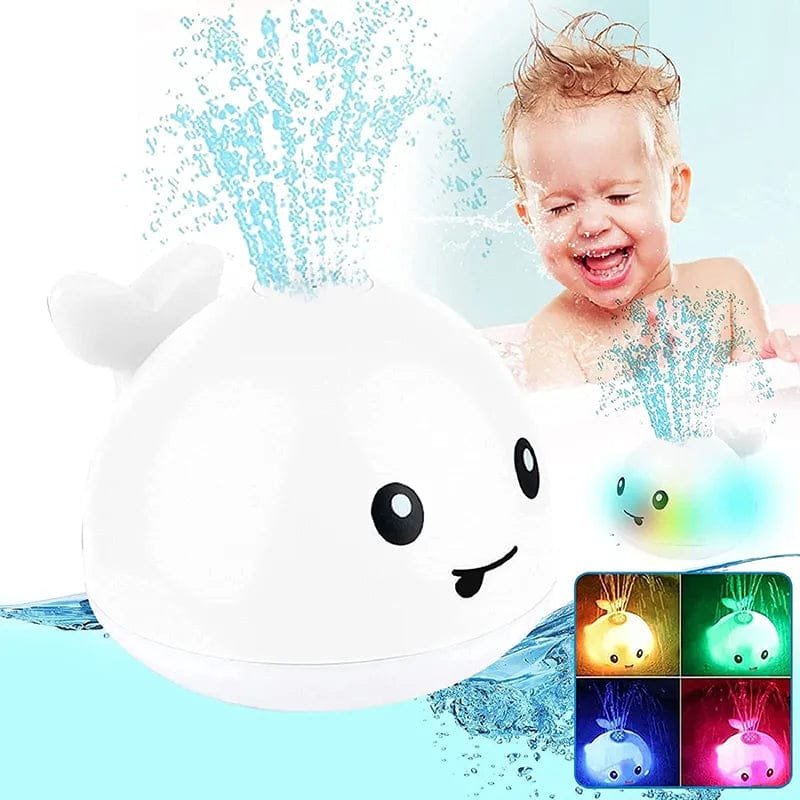 Baby playing with a toy whale in water, showing colorful lights on a small screen.