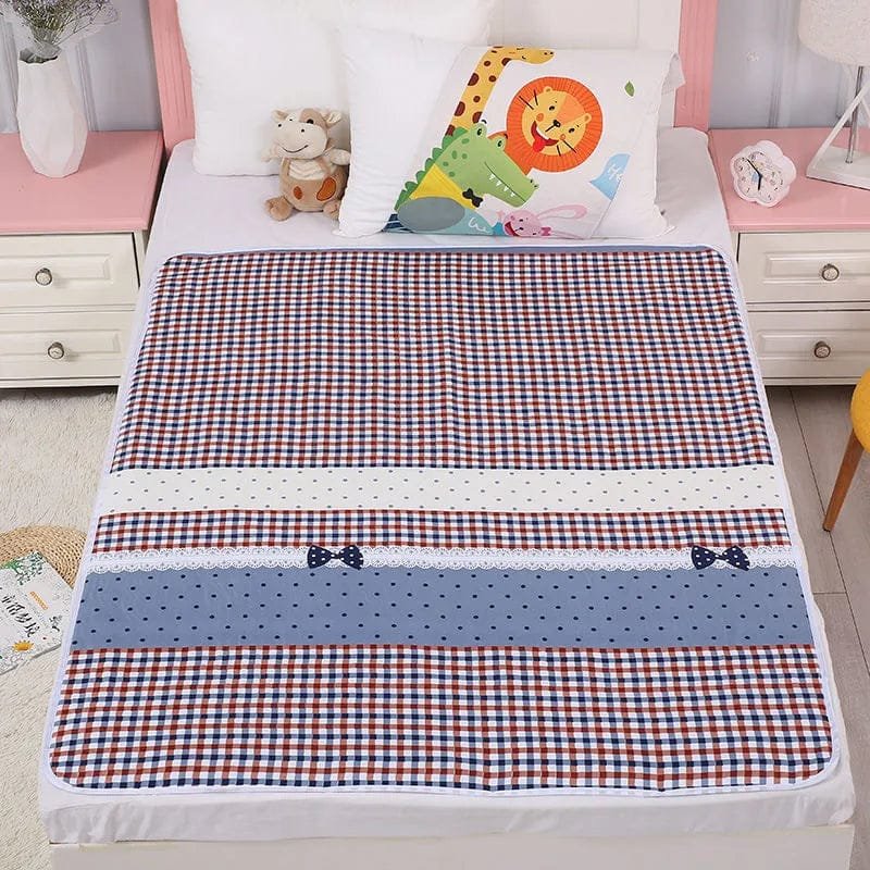 Checkered bedspread with colorful patterns on a bed in a room setting.