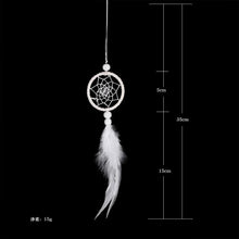 White feather dream catcher with a handwoven rattan frame for minimalist wall accents.
