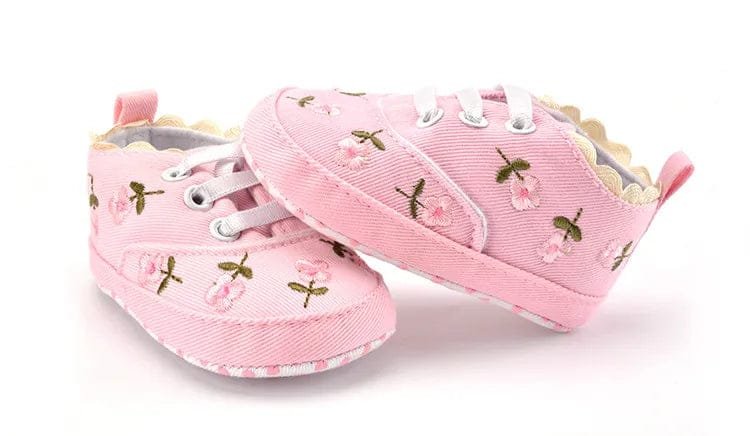 White floral lace infant shoes displayed as a standing pair, soft prewalkers for photo shoots and family gatherings.