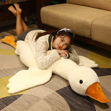Person lounging on the big White Goose Plush Toy pillow cushion, showing its large body pillow size.