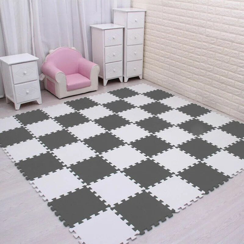 White and gray EVA foam puzzle mat providing floor protection during active toddler play.