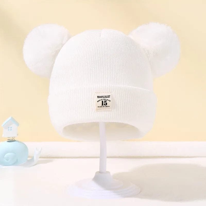 White Warm Knitted Baby Beanie with pom pom ears for cosy autumn and winter dressing on pram walks.