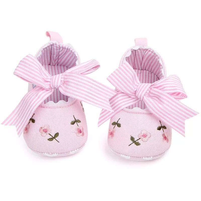 Back heel view of the white lace floral infant girl shoes, soft prewalkers for gentle everyday wear on tiny feet.