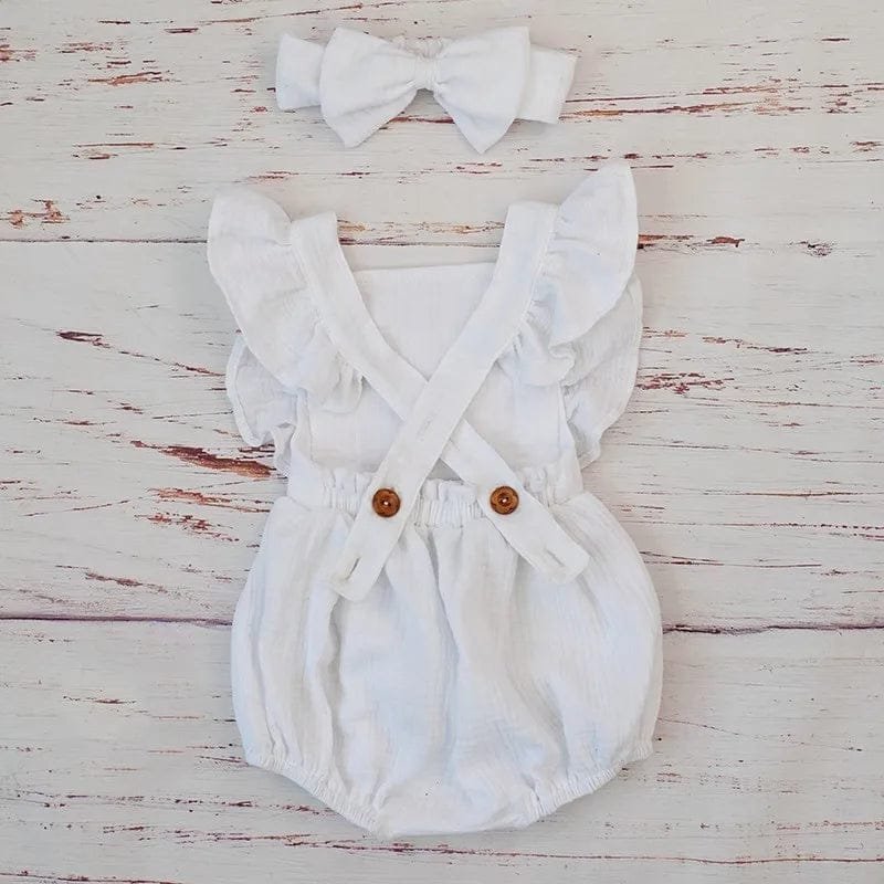 Button front detail on the white organic cotton ruffle romper, making nappy changes quick and fuss-free.