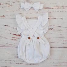 Button front detail on the white organic cotton ruffle romper, making nappy changes quick and fuss-free.