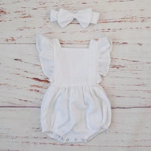 White ruffle sleeve romper and headband in organic cotton for christenings, photos, and gentle everyday baby wear.