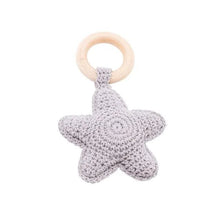 White star crochet baby rattle and teether wooden ring, a neutral toy for nursery decor and infant teething.