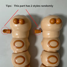 Close-up of two wind-up key styles on the side of the caterpillar toy, chosen at random