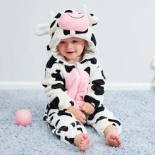 Cow winter flannel romper child on a blue carpet in a third photo showing the hooded animal design.