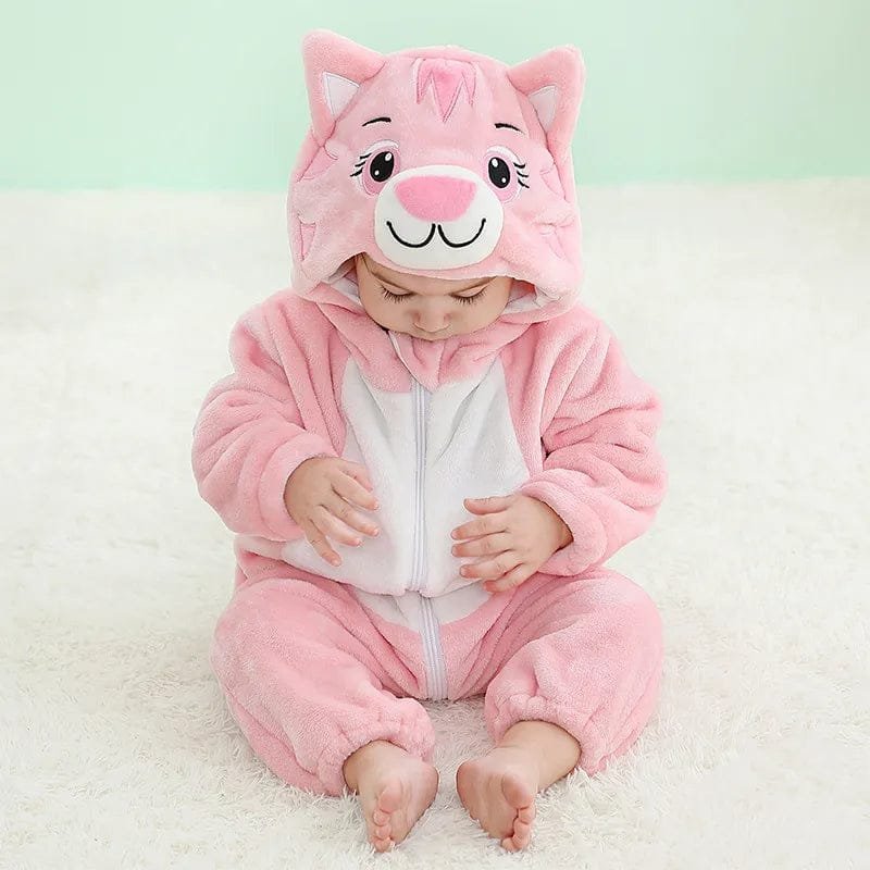 Baby girl in the pink cat winter flannel romper, a soft hooded onesie for bedtime warmth and winter photos.