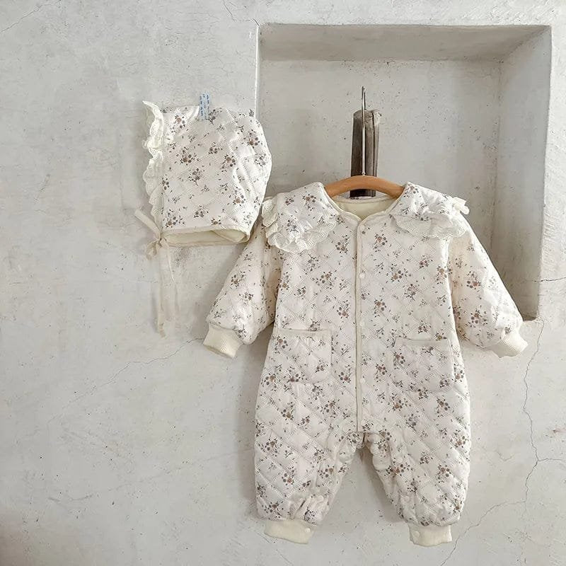 Front view of the winter floral toddler romper on a hanger, a quilted one-piece for nursery days and family walks.
