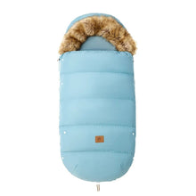 Blue winter stroller footmuff with fur trim, a warm sleeping cover for infants during cold-season pram journeys.