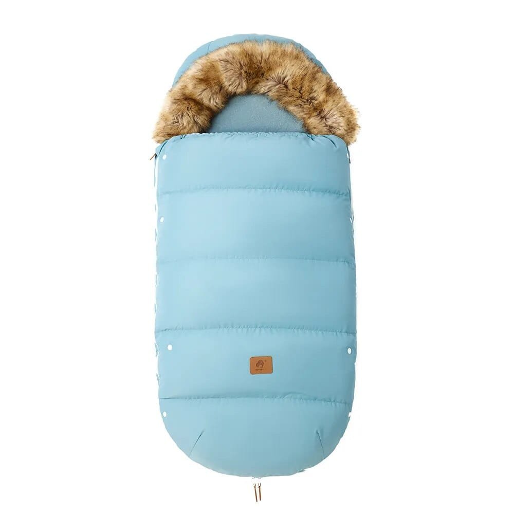 Blue winter stroller footmuff with fur trim, a warm sleeping cover for infants during cold-season pram journeys.