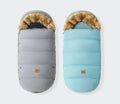 Winter stroller footmuff in grey and blue with fur trim, a waterproof cover for keeping babies warm on pram walks.