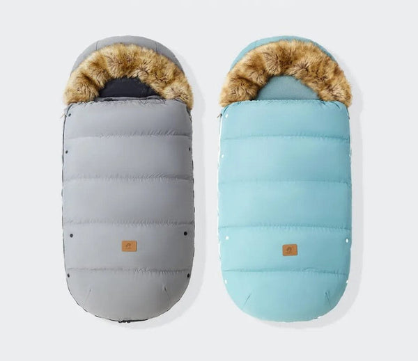 Winter stroller footmuff in grey and blue with fur trim, a waterproof cover for keeping babies warm on pram walks.