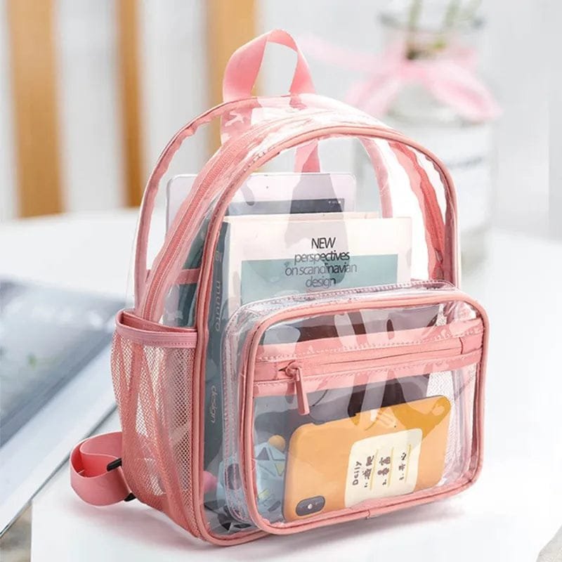 Pink clear PVC backpack for women packed with books and a phone, a see-through bag for stadiums and campus days.