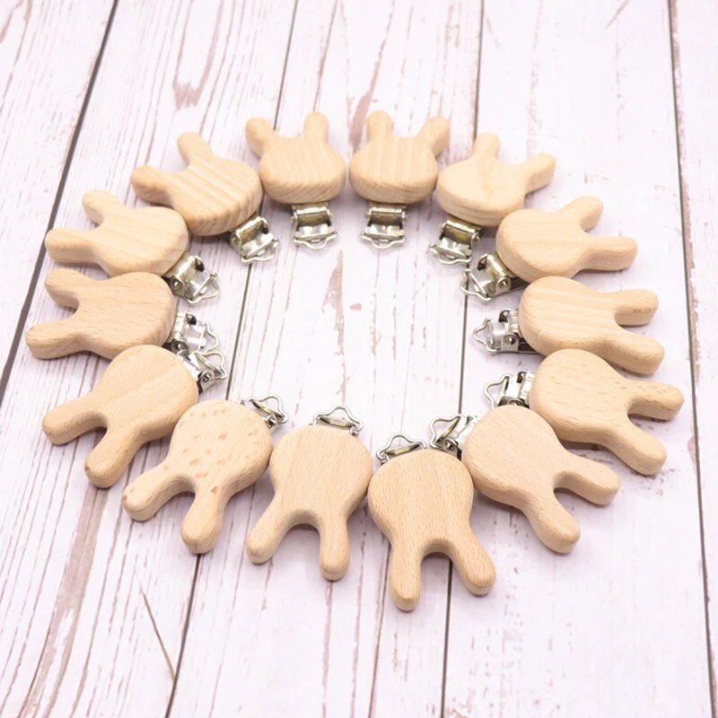 Wooden animal pacifier clips arranged in a circle to show shape variety, teether holders for daily soothing and baby shower gifting.