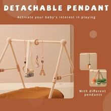 Wooden baby gym with detachable hanging pendants for sensory play and grasping practice.