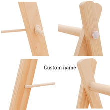 Wooden baby gym folded flat for space-saving nursery storage between tummy time and play sessions.