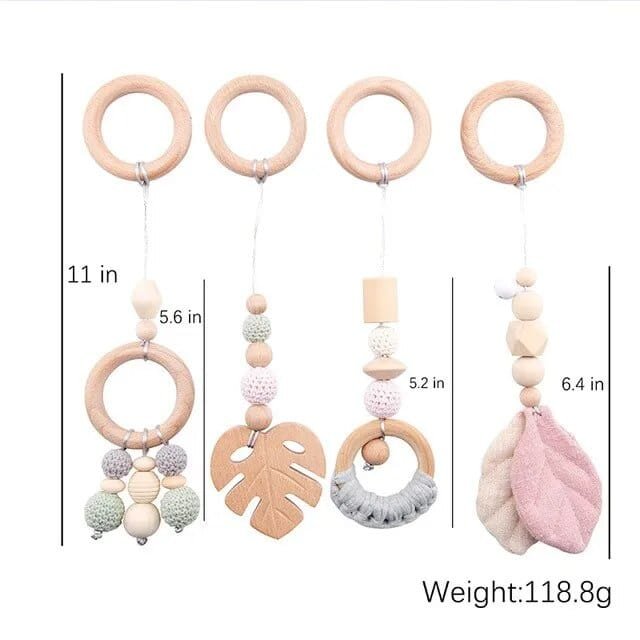 Wooden teething ring with colorful beads and leaf designs, showing measurements and weight on a white background.