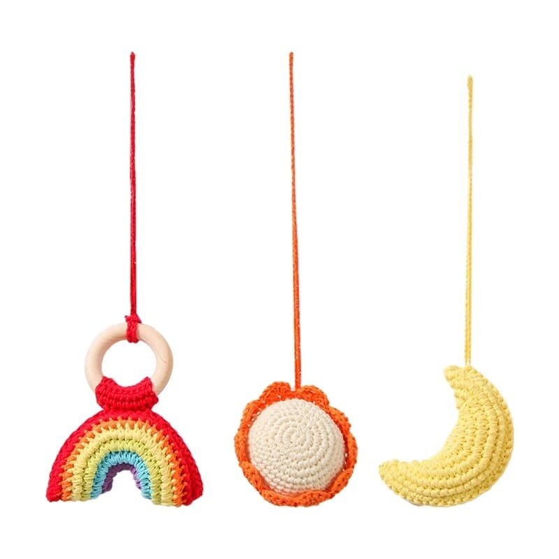 Three colorful crocheted toys hanging on a white background
