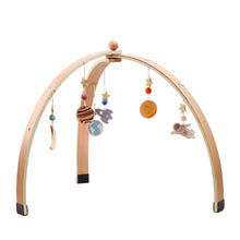 Star and planet mobile for the wooden baby play gym supporting sensory development during floor play.
